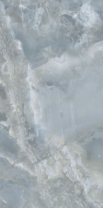Close-up of Thebes Blue Honed Matt Onyx 60x120cm porcelain tile featuring soft blue onyx-effect veining with layered white, grey and pale blue tones. The honed matt finish creates a luxurious natural stone look, perfect for bathroom walls, feature walls and elegant interiors.