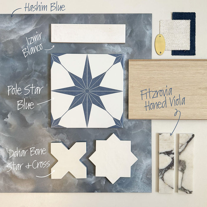 Flat lay moodboard featuring Hashim Blue Honed Matt Onyx tiles with a blue star patterned tile, white star and cross tiles, white gloss brick tiles, marble effect mosaic strips, light wood and brass accents, creating a timeless blue and white interior palette.