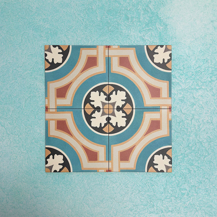 Four Europa Helsinki 20x20cm Victorian Moroccan style tiles arranged together to showcase the repeating geometric pattern in teal, terracotta, cream and black tones, displayed against a textured aqua background.