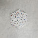 Single Confetti Tutti Frutti Hexagon 22×25cm terrazzo-style porcelain tile featuring colourful multitone chips on a white base, displayed against a light textured background.