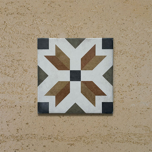Single tile from the Carnaby High Street Victorian-style collection, 20x20cm porcelain wall and floor tile, featuring a bold geometric star motif in mustard, olive, brown, white, and charcoal tones on an aged background.