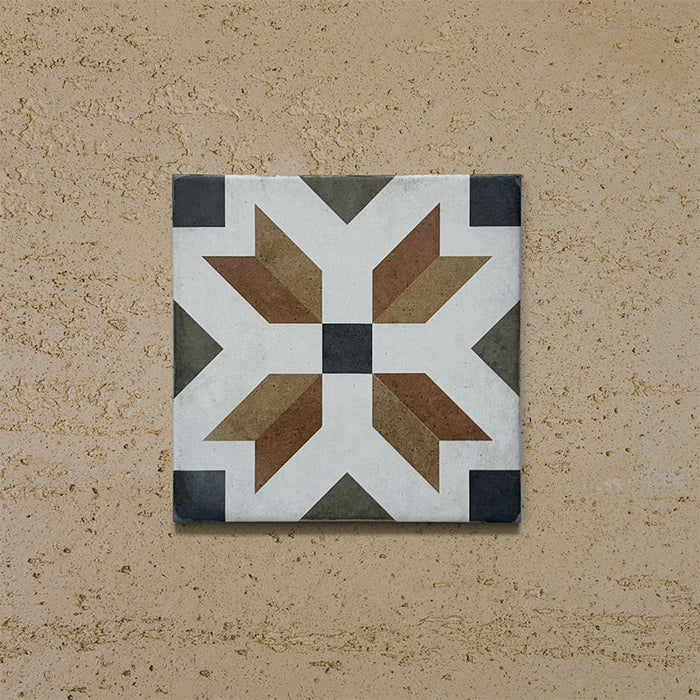 Single tile from the Carnaby High Street Victorian-style collection, 20x20cm porcelain wall and floor tile, featuring a bold geometric star motif in mustard, olive, brown, white, and charcoal tones on an aged background.