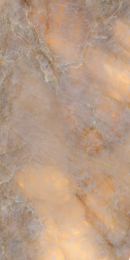 Close-up of Illuminati Precious Stone Amber 60 × 120cm polished porcelain tiles, featuring warm amber, cream, and taupe gemstone-inspired tones with delicate veining, luminous detailing, and a high-gloss natural stone effect finish.