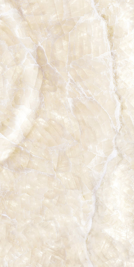 Close-up of Illuminati Precious Stone Ivory 60 × 120cm polished porcelain tiles, featuring soft ivory and cream gemstone-inspired tones with delicate veining, luminous detailing, and a refined high-gloss natural stone effect finish.