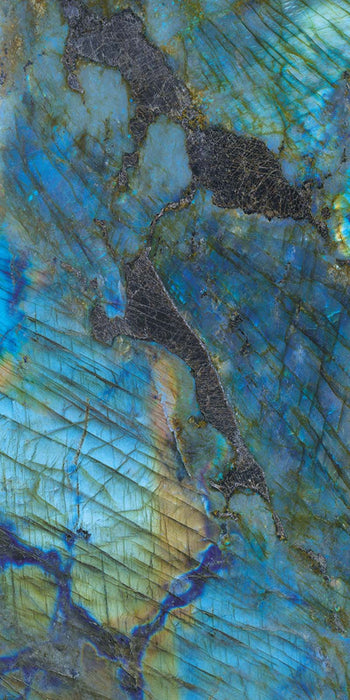 Close-up of Illuminati Precious Stone Labradorite 60 × 120cm polished porcelain tiles, featuring dramatic blue, charcoal, and iridescent gemstone-inspired veining with a high-gloss finish and striking natural stone effect detailing.