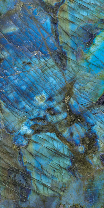Close-up of Illuminati Precious Stone Labradorite 60 × 120cm polished porcelain tiles, featuring dramatic blue, charcoal, and iridescent gemstone-inspired veining with a high-gloss finish and striking natural stone effect detailing.