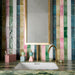 Bathroom setting featuring Fusion collection gloss brick tiles in a vertical striped layout, blending soft greens, pinks and neutrals, paired with a marble vanity and brass fittings for a vibrant, design-led finish.