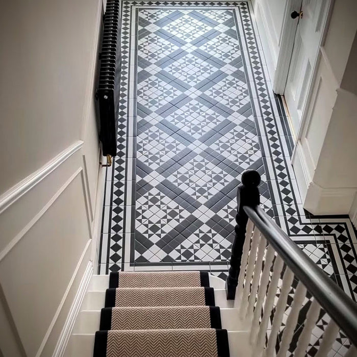 Hallway and stair landing featuring Sloane Square 25x25cm Victorian-style black and white floor tiles, installed in a geometric pattern with border detail, styled with staircase, runner, and classic interior features.