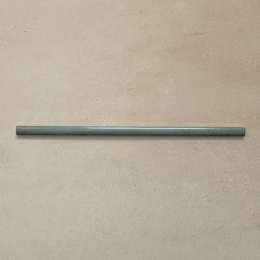 Izmir Celadon Green Gloss Pencil Bullnose Border Tile 1.2x30cm displayed on a neutral beige background, showing its slim curved edge and smooth glazed finish.