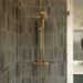 Contemporary walk-in shower featuring Izmir Sage Green gloss brick wall tiles, Agraba Natural Moroccan style patterned floor tiles, large terrazzo effect wall tiles, brushed brass shower fittings and a floating sage green vanity for a warm, modern bathroom.