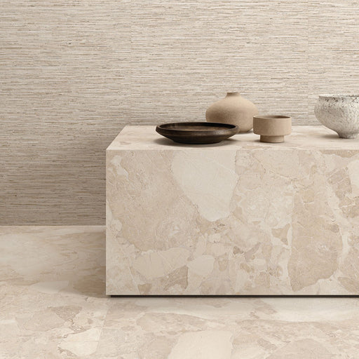 Interior featuring Jeddah Avorio Sassi Terrazzo Stone 60x60cm stone-effect wall and floor tiles, showcasing warm ivory and beige tones with natural stone-inspired detailing, styled with matching tiled cabinetry and light wood shelving for a contemporary finish.