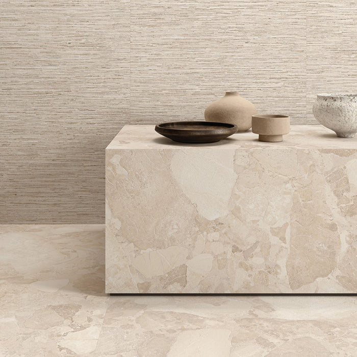 Interior featuring Jeddah Avorio Sassi Terrazzo Stone 60x60cm stone-effect wall and floor tiles, showcasing warm ivory and beige tones with natural stone-inspired detailing, styled with matching tiled cabinetry and light wood shelving for a contemporary finish.