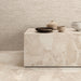 Interior featuring Jeddah Avorio Sassi Terrazzo Stone 60x60cm stone-effect wall and floor tiles, showcasing warm ivory and beige tones with natural stone-inspired detailing, styled with matching tiled cabinetry and light wood shelving for a contemporary finish.