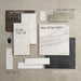 Moodboard featuring Jesi Travertine 60x60cm travertine effect wall and floor tiles, paired with Obsidian Stone Silk, Haven Antique White, Haven Antique Black, Zellij Oyster, Zellij Weald Green and Madison White tiles, alongside warm wood, soft white and charcoal accents for a timeless, contemporary scheme.