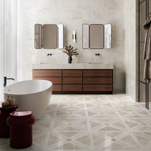 Bathroom featuring Jesi Travertine Decor 60x60cm travertine effect wall and floor tiles, showcasing a geometric linear pattern in warm cream and beige tones, paired with a freestanding bath, walnut vanity unit and contemporary styling for a luxurious, elegant interior.