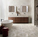 Bathroom featuring Jesi Travertine Decor 60x60cm travertine effect wall and floor tiles, showcasing a geometric linear pattern in warm cream and beige tones, paired with a freestanding bath, walnut vanity unit and contemporary styling for a luxurious, elegant interior.