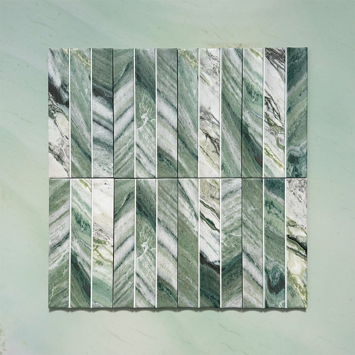 Product display of Kalamata Fluted Green Matt 11.5x23cm wall tiles in rich green marble-effect tones, featuring fluted detailing with natural veining against a soft green stone-effect backdrop.