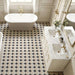 Classic bathroom featuring Kasuf Night 20x20cm terrazzo-style decor floor tiles, styled with a freestanding bath, marble vanity, and brushed brass fixtures for an elegant monochrome interior with a timeless geometric look.
