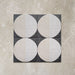 Kasuf Night 20x20cm terrazzo-style decor tiles featuring a bold monochrome circular pattern with speckled terrazzo detailing, ideal for creating statement floors and contemporary geometric interiors.