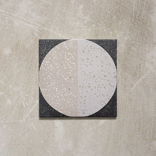 Kasuf Night 20x20cm terrazzo-style decor tiles featuring a bold monochrome circular pattern with speckled terrazzo detailing, ideal for creating statement floors and contemporary geometric interiors.
