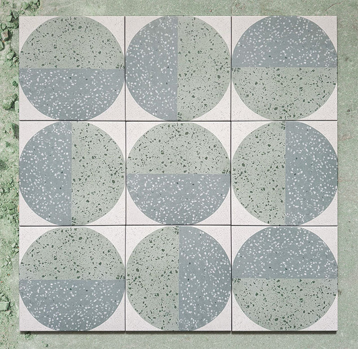 Kasuf Verde 20x20cm terrazzo-style decor tiles featuring a soft sage green and pale blue circular pattern with speckled terrazzo detailing, perfect for creating calming geometric floors and contemporary statement interiors.