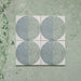 Kasuf Verde 20x20cm terrazzo-style decor tiles featuring a soft sage green and pale blue circular pattern with speckled terrazzo detailing, perfect for creating calming geometric floors and contemporary statement interiors.
