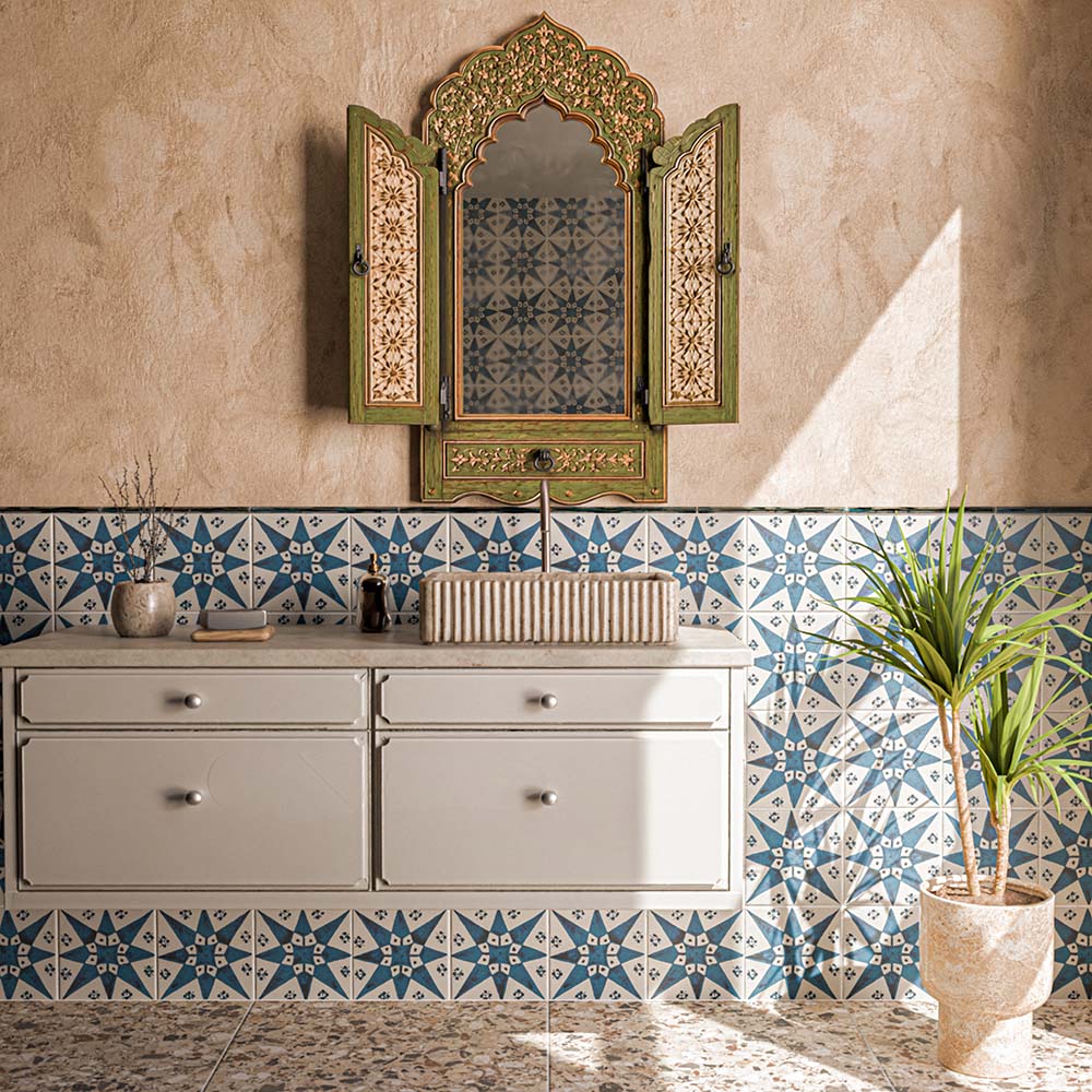 Bathroom featuring Kazhan Star Navy Blue 20x20cm Moroccan-style patterned wall tiles, paired with textured beige walls, a floating vanity, decorative carved mirror and terrazzo-effect floor tiles.