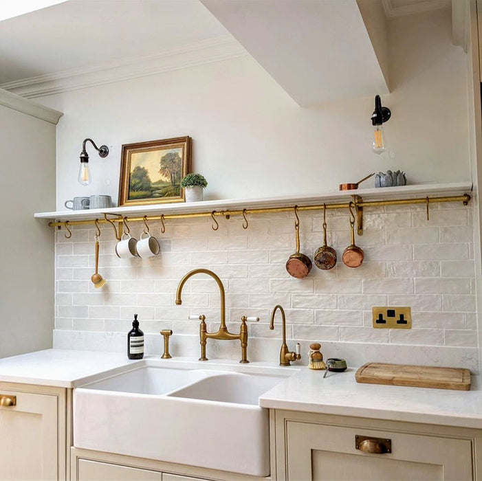 Kitchen splashback featuring Zellij Oyster Brick Moroccan-style tiles in a 6.5cm x 20cm format, with a glossy off-white finish, styled with brass fittings, open shelving, and a classic farmhouse sink.