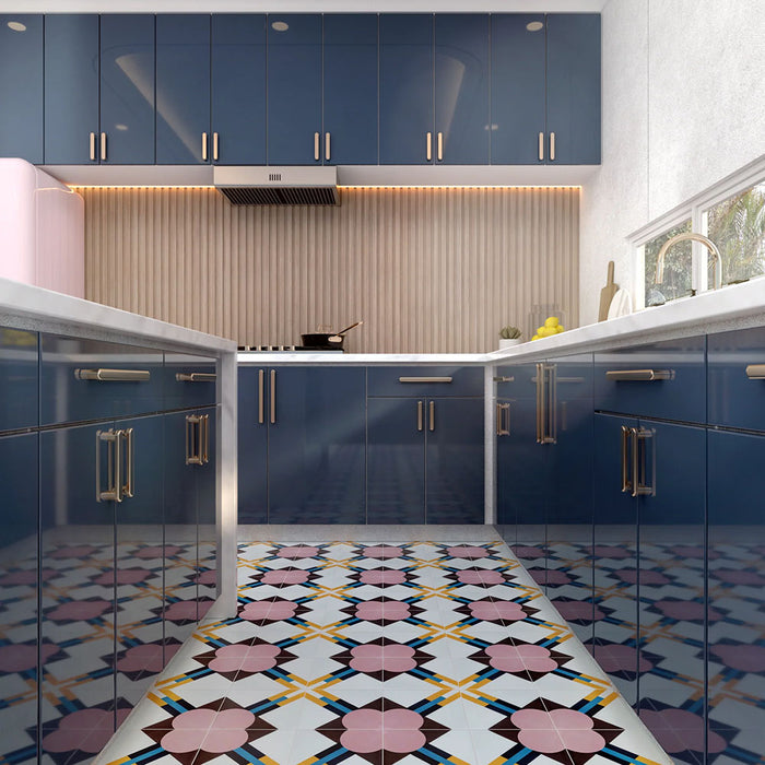 Geometry Contour patterned tiles in a 20x20cm size used as a bold kitchen floor feature, showcasing pink floral-style motifs with mustard and teal intersecting lines on a light base. The colourful geometric pattern contrasts with glossy navy cabinets, marble countertops, a ribbed beige backsplash, and soft warm lighting for a modern, vibrant kitchen design.
