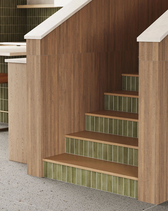 Kitchen featuring Atlas Verde Mini Brick 5x15cm matt wall tiles, installed in a vertical layout, showcasing rich green tones with a subtle textured finish, paired with wood cabinetry and a warm, contemporary interior setting.