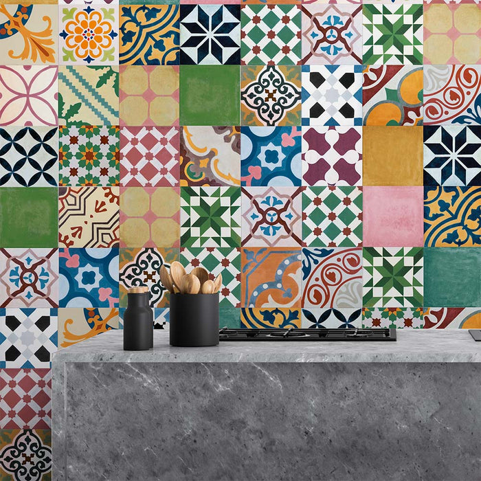 Kitchen setting featuring Fihrdos Mini Patchwork Moroccan-style 15x15cm patterned porcelain wall tiles, showcasing a vibrant mix of colourful geometric designs behind a modern stone island.