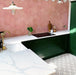 Alhambra Palacio 20x20cm Moroccan tiles in a modern kitchen setting featuring dark green cabinets, marble countertops, and pink hexagonal wall tiles, creating a bold yet elegant contrast with the geometric patterned floor.