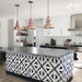 Alhambra Alkazar 20x20cm Moroccan tiles used on a modern kitchen island, featuring a bold black and white geometric pattern that contrasts beautifully with white cabinetry, copper pendant lights, and a sleek grey countertop.