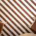 Kutani Cotto 9.1cm x 37.5cm porcelain tiles, paired with Kutani Vanilla in a bold striped layout that highlights the warm terracotta tone and clean linear format.