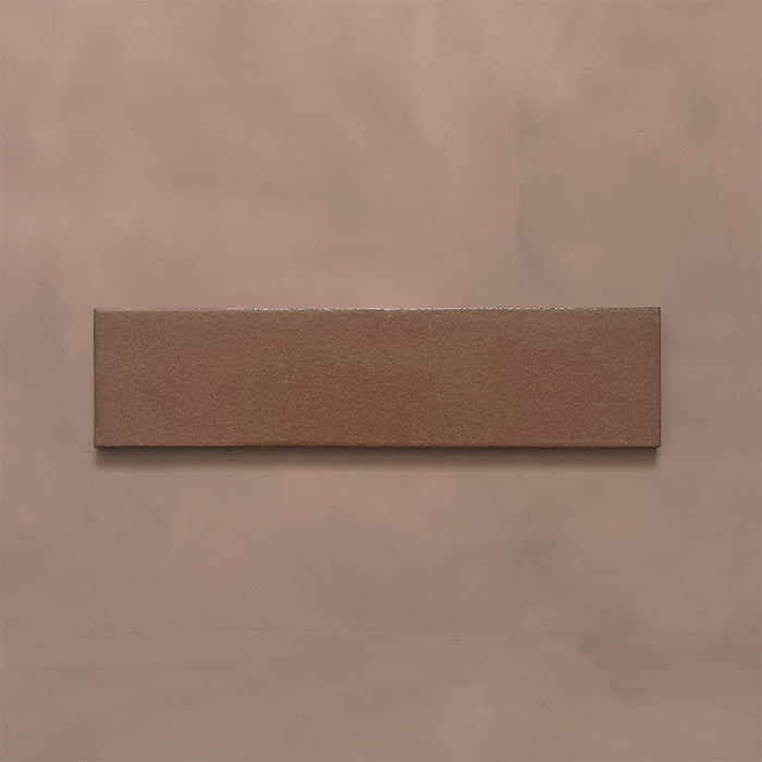 Single Kutani Cotto 9.1cm x 37.5cm porcelain wall and floor tile, featuring a warm terracotta-brown finish with subtle tonal variation and softly irregular edges.