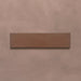 Single Kutani Cotto 9.1cm x 37.5cm porcelain wall and floor tile, featuring a warm terracotta-brown finish with subtle tonal variation and softly irregular edges.