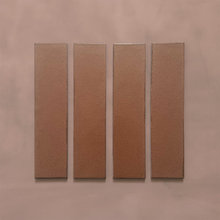 Kutani Cotto 9.1cm x 37.5cm porcelain wall and floor tile, featuring a warm terracotta-brown finish with subtle tonal variation and softly irregular edges.