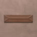 Single Kutani Decor Cotto 9.1cm x 37.5cm porcelain wall tile, featuring a warm terracotta-brown finish with raised geometric detailing, subtle tonal variation and softly irregular edges.