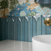 Kutani Decor Laguna Blue 9.1cm x 37.5cm porcelain wall tiles, showcasing a sculpted geometric surface in rich blue tones, paired with botanical wallpaper, a white marble effect basin and brushed brass fittings.
