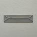 Single Kutani Decor Lichen Green 9.1cm x 37.5cm porcelain wall tile, featuring a muted grey-green finish with raised geometric detailing, subtle tonal variation and softly irregular edges.