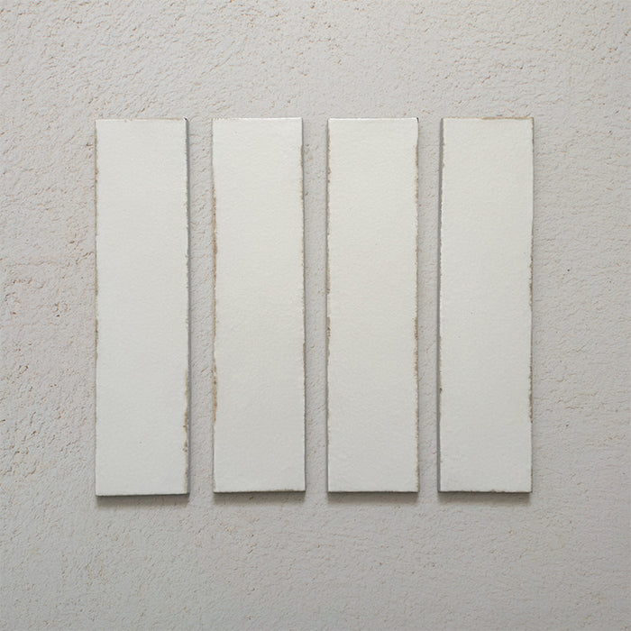 Kutani Vanilla 9.1cm x 37.5cm porcelain wall and floor tile, featuring a soft off-white finish with subtle tonal variation and gently irregular edges for a handcrafted look.