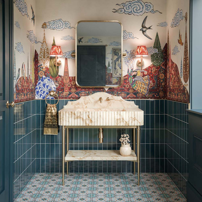 Bathroom featuring Kyoto Blue 6.5x20cm Moroccan handmade-style brick wall tiles, laid vertically in a rich blue shade, paired with patterned floor tiles, decorative wallpaper and a marble washbasin.