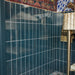 Close-up of Kyoto Blue 6.5x20cm Moroccan handmade-style brick wall tiles, featuring a glossy blue finish and vertical layout, complemented by colourful decorative wallpaper and brass bathroom accessories.