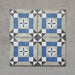 Four-tile layout of Carnaby Lane Victorian-style 20x20cm porcelain wall and floor tiles, highlighting the blue and taupe geometric border design with a central floral motif on an aged neutral background.
