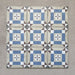 Grouped layout of Carnaby Lane Victorian-style 20x20cm porcelain wall and floor tiles, showing the full repeating blue and taupe geometric border design with central floral motifs on an aged neutral background.