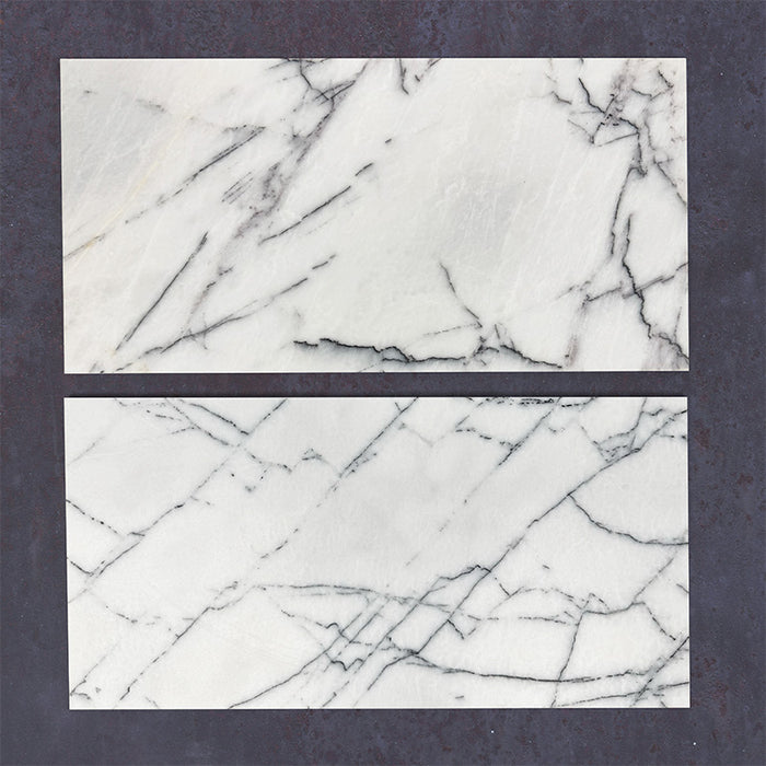 Close-up of Fitzrovia Lilac natural marble tiles in a honed finish, 30.5x61cm format, showcasing a soft white base with delicate lilac and grey veining, creating a subtle yet refined look for wall and floor applications.