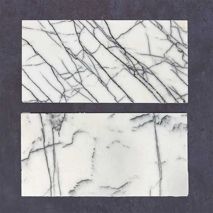 Close-up of Fitzrovia Lilac natural marble tiles in a honed finish, 30.5x61cm format, showcasing a soft white base with delicate lilac and grey veining, creating a subtle yet refined look for wall and floor applications.
