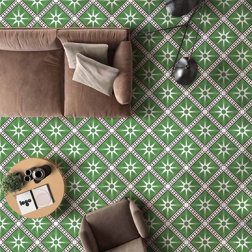 Galata Green Moroccan Style 20x20cm tiles used in a living room setting, featuring a striking green background with white star motifs and black geometric borders, paired with a neutral brown sofa and modern décor.