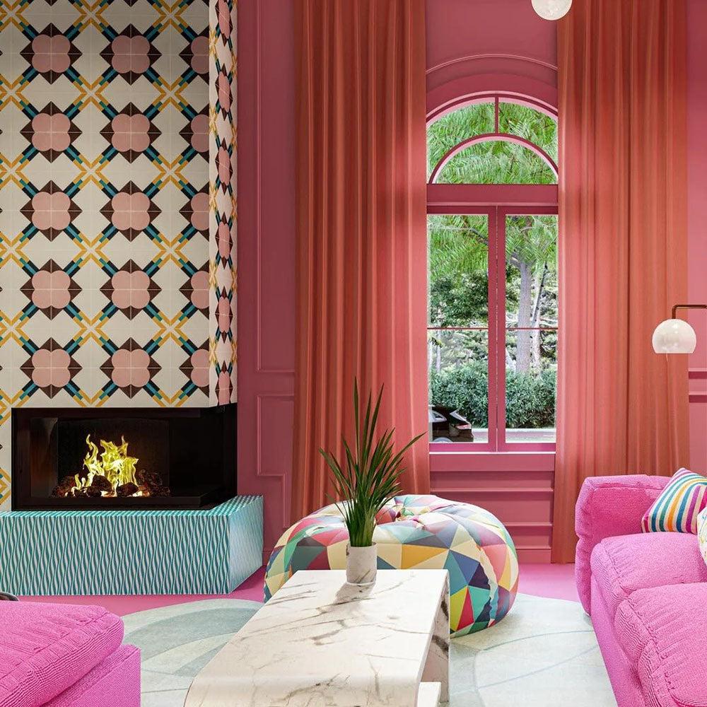 Living room featuring Geometry Contour 20x20cm patterned ceramic tiles used as a statement fireplace surround, showcasing a retro-inspired geometric motif in pink, yellow, teal, and brown tones, styled within a vibrant interior with pink walls, bold furnishings, and large arched windows.