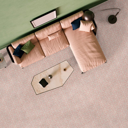Living room featuring Iris Pink Victorian Moroccan-style 20x20cm patterned porcelain floor tiles, styled with a soft neutral sofa, contemporary lighting, and pastel-toned décor.